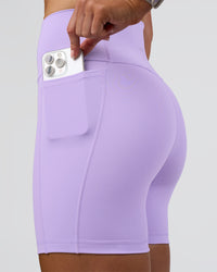 Woman wearing Fusion Ultra High-Rise 6" Short Pockets - Pale Lilac | Set:true | Angle:closeup | Model:Emelia | Size:S | Thumbnail Index: 1