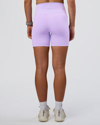 Woman wearing Fusion Ultra High-Rise 6" Short Pockets - Pale Lilac | Set:true | Angle:back | Model:Emelia | Size:S | Thumbnail Index: 3