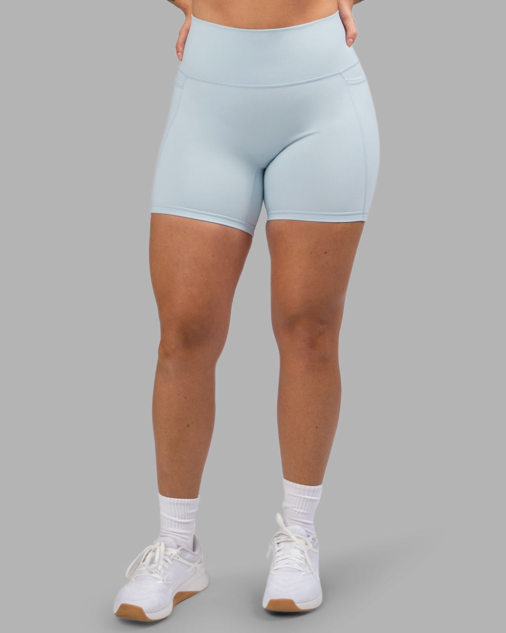 Woman wearing Fusion Ultra High-Rise 6" Short Pockets - Skyride| Model:Robyn | Size:S
