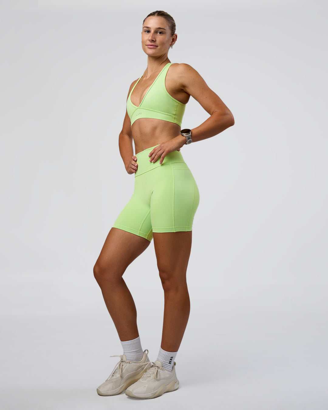 Woman wearing Fusion Ultra High-Rise 6" Short Pockets - Solar Lime | Model:Emelia | Size:S - view 5