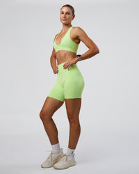 Woman wearing Fusion Ultra High-Rise 6" Short Pockets - Solar Lime | Model:Emelia | Size:S | Thumbnail Index: 4