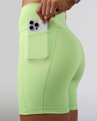 Woman wearing Fusion Ultra High-Rise 6" Short Pockets - Solar Lime | Set:true | Angle:closeup | Model:Emelia | Size:S | Thumbnail Index: 1