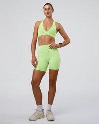 Woman wearing Fusion Ultra High-Rise 6" Short Pockets - Solar Lime | Model:Emelia | Size:S | Thumbnail Index: 0