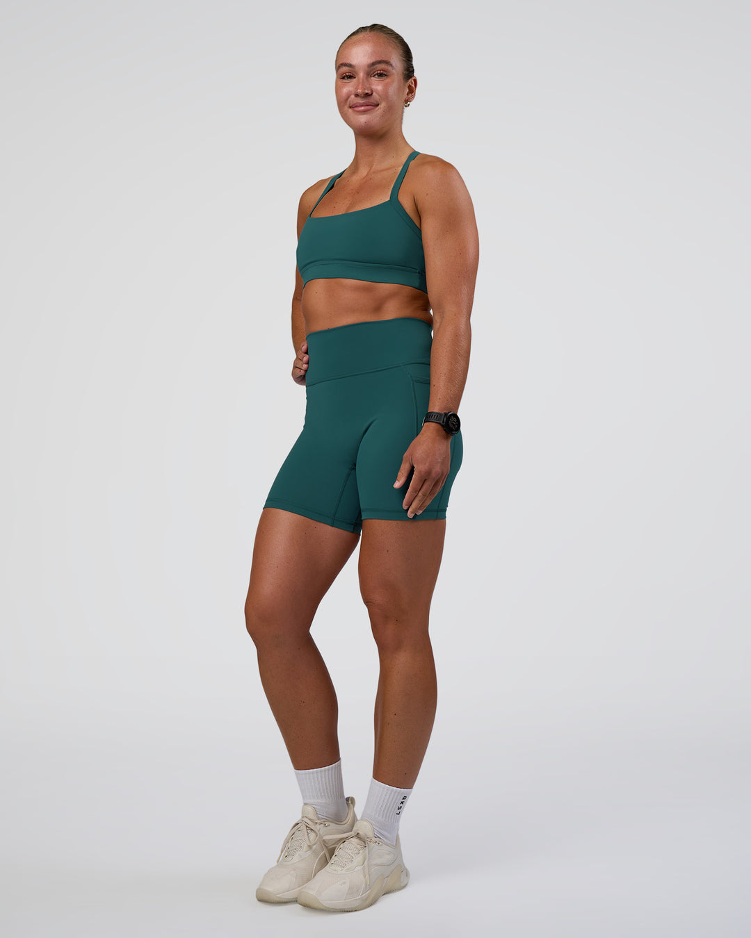 Woman wearing Fusion Ultra High-Rise 6" Short Pockets - Transformative Teal | Model:Sav | Size:S - view 5