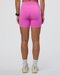 Woman wearing Fusion Ultra High-Rise 6" Short Pockets - Ultra Fuchsia | Set:true | Angle:back | Model:Abbey | Size:S | Thumbnail Index: 3