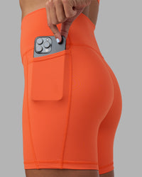 Woman wearing Fusion Ultra High-Rise 6" Short Pockets - Ultra Orange | Set:true | Angle:closeup | Model:Katie | Size:S | Thumbnail Index: 1