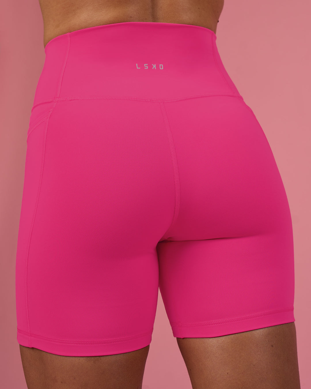 Woman wearing Fusion Ultra High-Rise 6" Short Pockets - Ultra Pink | Set:true | Angle:back | Model:Hannah | Size:S - view 4
