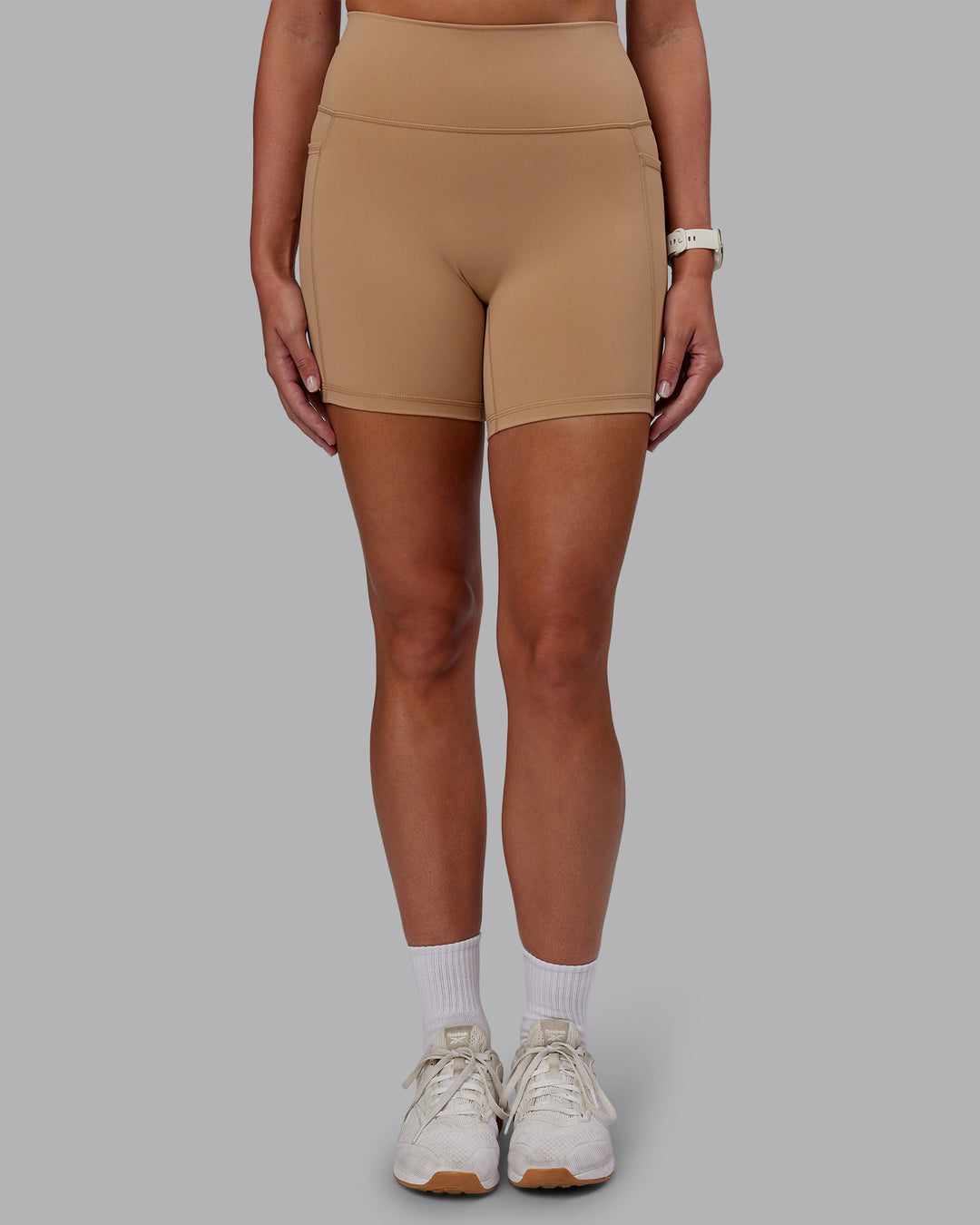 Woman wearing Fusion Ultra High-Rise 6" Short Pockets - Warm Smoke | Set:true | Angle:front | Model:Phoebe | Size:S - view 2