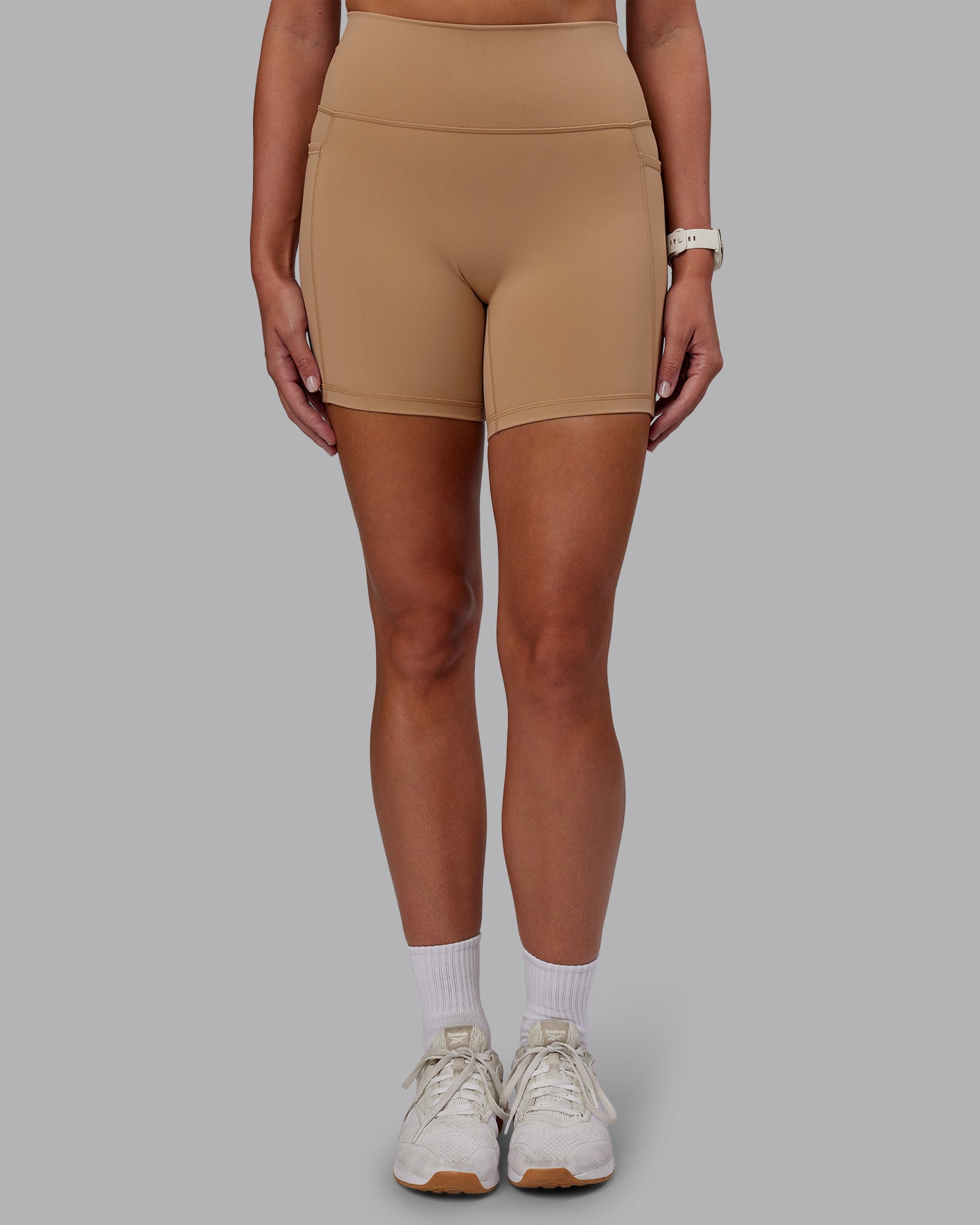 Woman wearing Fusion Ultra High-Rise 6" Short Pockets - Warm Smoke | Set:true | Angle:front | Model:Phoebe | Size:S