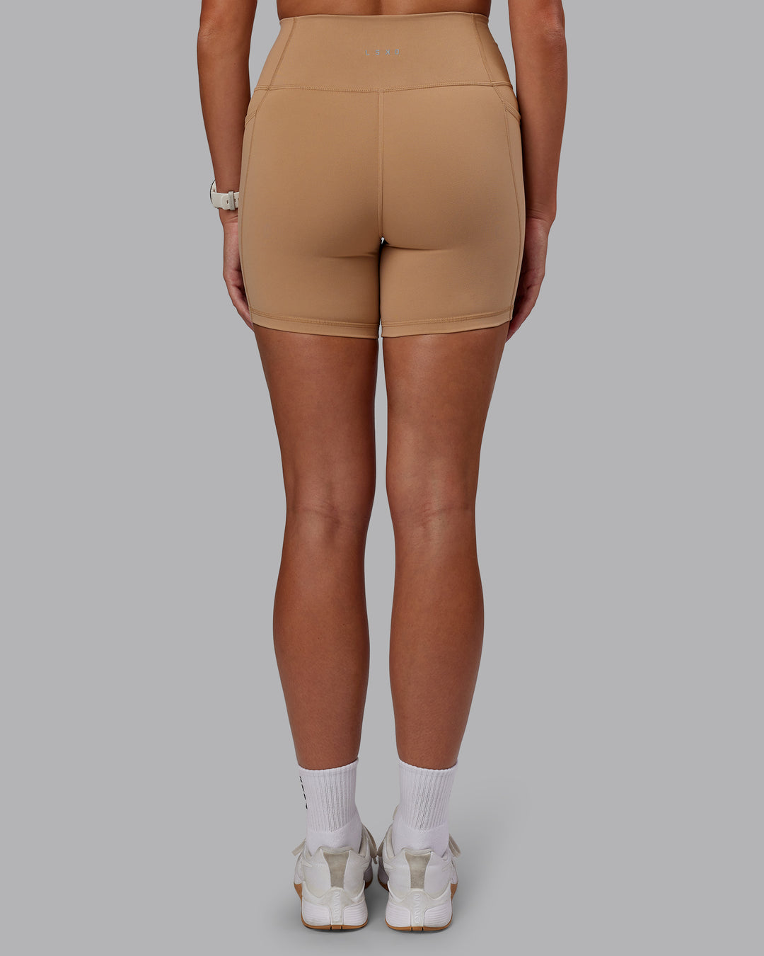 Woman wearing Fusion Ultra High-Rise 6" Short Pockets - Warm Smoke | Set:true | Angle:back | Model:Phoebe | Size:S - view 4