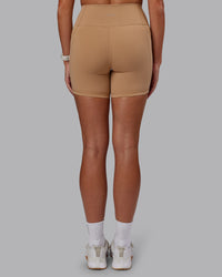 Woman wearing Fusion Ultra High-Rise 6" Short Pockets - Warm Smoke | Set:true | Angle:back | Model:Phoebe | Size:S | Thumbnail Index: 3
