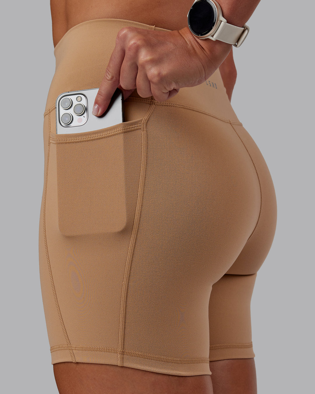 Woman wearing Fusion Ultra High-Rise 6" Short Pockets - Warm Smoke | Set:true | Angle:closeup | Model:Phoebe | Size:S - view 1