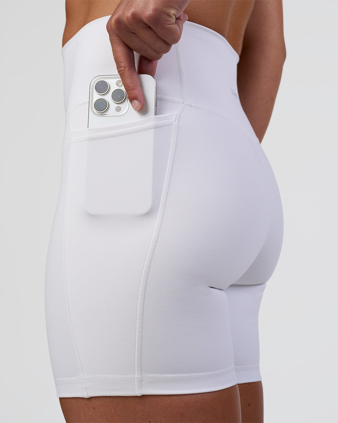 Woman wearing Fusion Ultra High-Rise 6" Short Pockets - White | Set:true | Angle:closeup | Model:Sav | Size:S - view 1