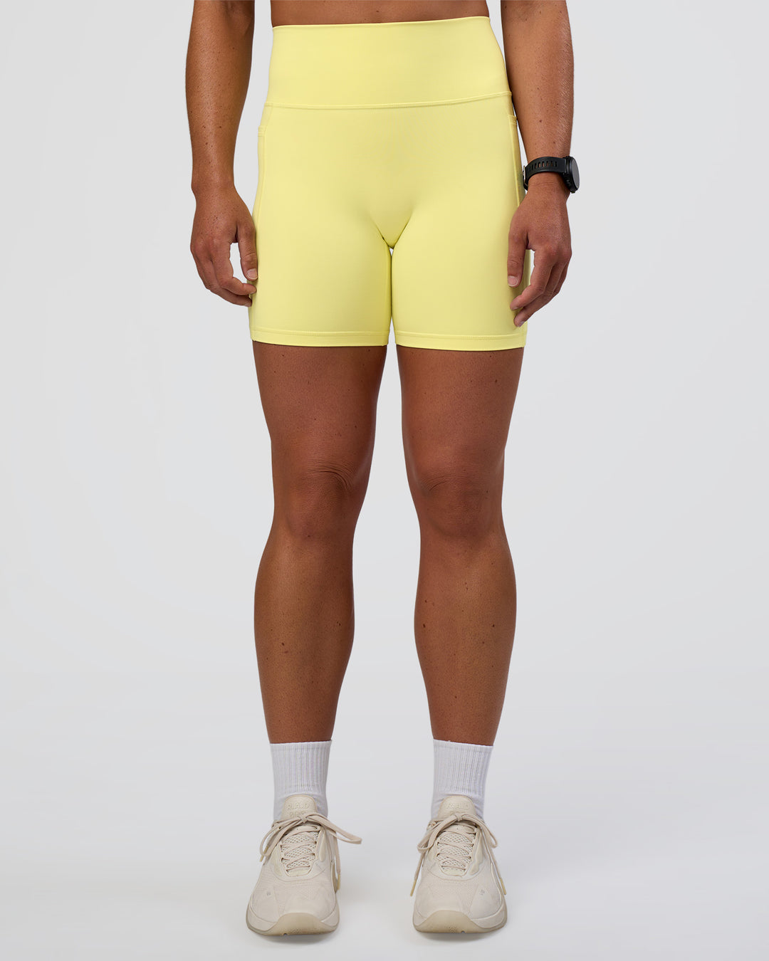 Woman wearing Fusion Ultra High-Rise 6" Short Pockets - Yellow Fizz | Set:true | Angle:front | Model:Sav | Size:S - view 1