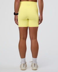 Woman wearing Fusion Ultra High-Rise 6" Short Pockets - Yellow Fizz | Set:true | Angle:back | Model:Sav | Size:S | Thumbnail Index: 3