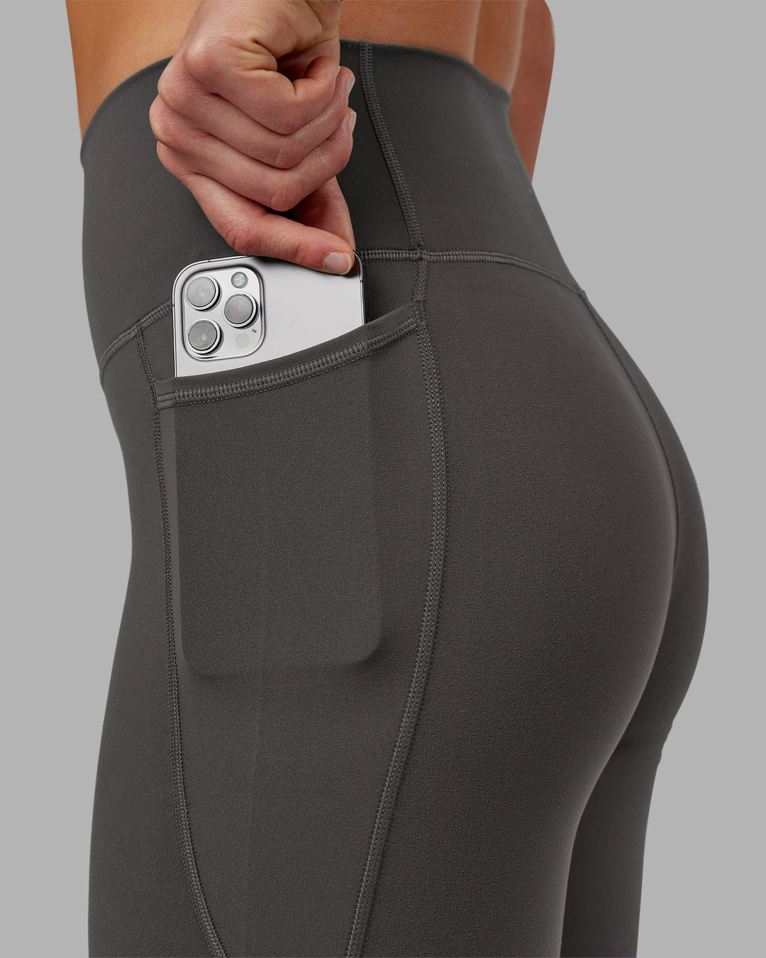 Woman wearing Fusion Ultra High-Rise 7/8 Legging Pockets - Dark Storm | Model:Keisha | Size:S - view 3