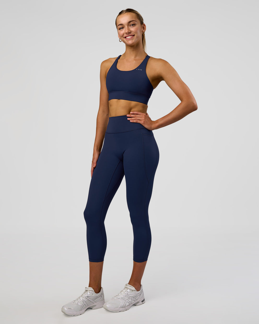 Woman wearing Fusion Ultra High-Rise 7/8 Legging Pockets - Future Navy | Model:Evie | Size:S - view 2