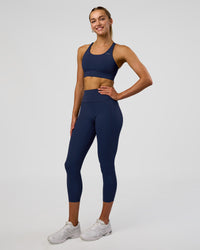 Woman wearing Fusion Ultra High-Rise 7/8 Legging Pockets - Future Navy | Model:Evie | Size:S | Thumbnail Index: 1