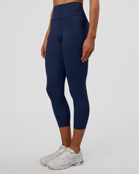 Woman wearing Fusion Ultra High-Rise 7/8 Legging Pockets - Future Navy | Model:Evie | Size:S | Thumbnail Index: 2