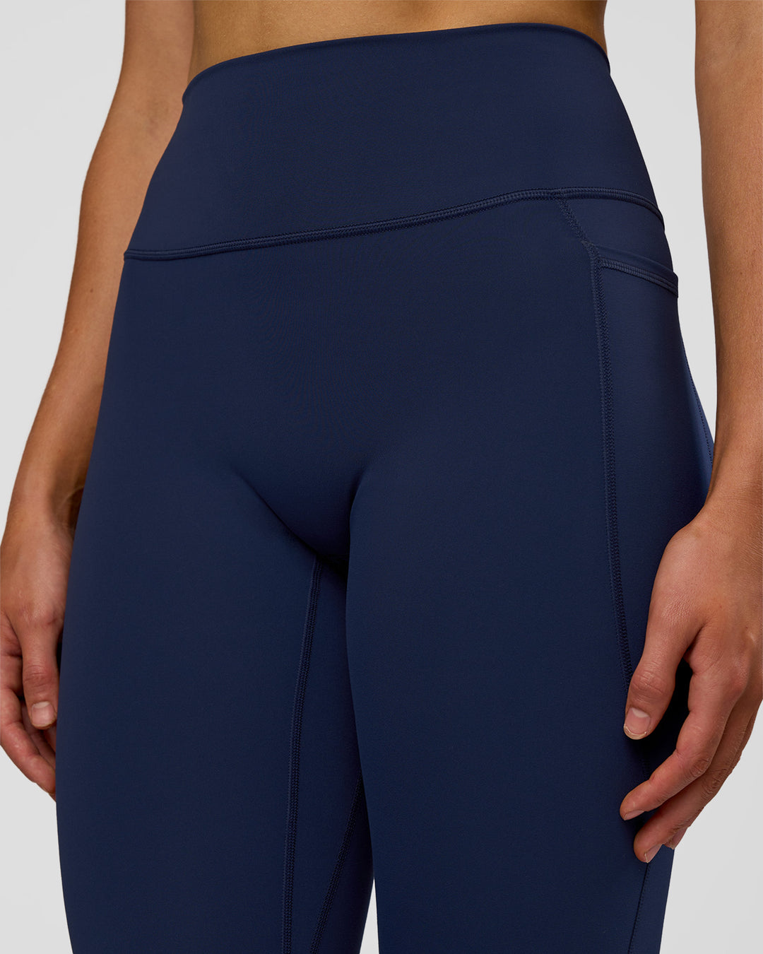 Woman wearing Fusion Ultra High-Rise 7/8 Legging Pockets - Future Navy | Model:Evie | Size:S - view 6