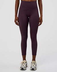 Woman wearing Fusion Ultra High-Rise 7/8 Legging Pockets - Midnight Plum | Model:Ellie | Size:S | Thumbnail Index: 1