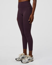 Woman wearing Fusion Ultra High-Rise 7/8 Legging Pockets - Midnight Plum | Model:Ellie | Size:S | Thumbnail Index: 0