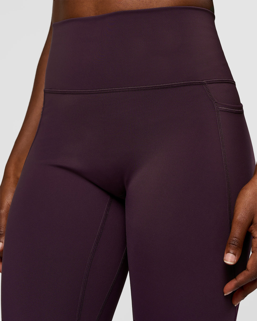 Woman wearing Fusion Ultra High-Rise 7/8 Legging Pockets - Midnight Plum | Model:Ellie | Size:S - view 3