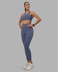 Woman wearing Fusion Ultra High-Rise 7/8 Legging Pockets - Night Shadow | Model:Rhiley | Size:S | Thumbnail Index: 0
