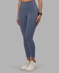 Woman wearing Fusion Ultra High-Rise 7/8 Legging Pockets - Night Shadow | Model:Rhiley | Size:S | Thumbnail Index: 1