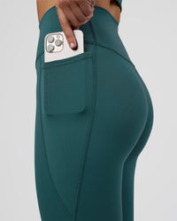 Woman wearing Fusion Ultra High-Rise 7/8 Legging Pockets - Transformative Teal | Model:Myrte | Size:S | Thumbnail Index: 2