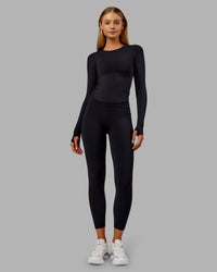 Woman wearing Fusion Ultra High-Rise 7/8 Thermal Legging Pockets - Black | Model:Ella | Size:S | Thumbnail Index: 0