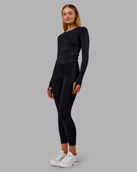 Woman wearing Fusion Ultra High-Rise 7/8 Thermal Legging Pockets - Black | Model:Ella | Size:S | Thumbnail Index: 5