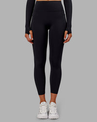 Woman wearing Fusion Ultra High-Rise 7/8 Thermal Legging Pockets - Black | Model:Ella | Size:S | Thumbnail Index: 1