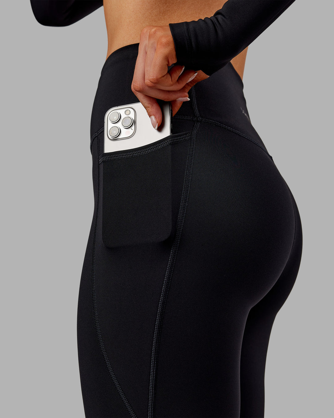 Woman wearing Fusion Ultra High-Rise 7/8 Thermal Legging Pockets - Black | Model:Ella | Size:S - view 3