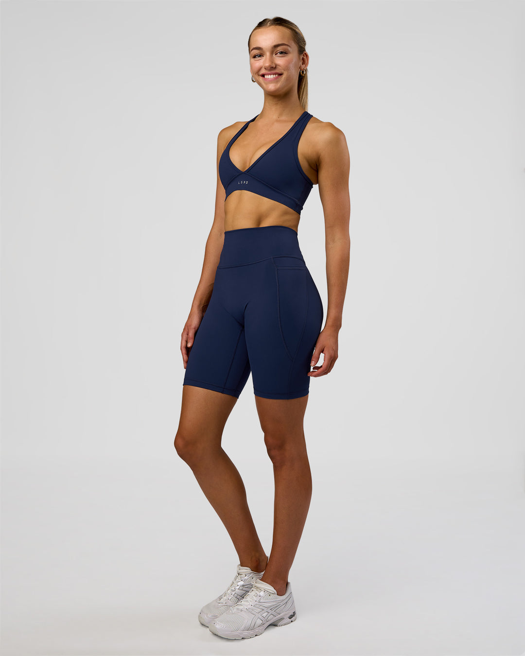 Woman wearing Fusion Ultra High-Rise 9" Short Pockets - Future Navy | Model:Evie | Size:S - view 4