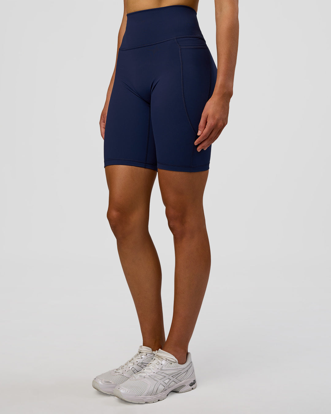 Woman wearing Fusion Ultra High-Rise 9" Short Pockets - Future Navy | Model:Evie | Size:S - view 5