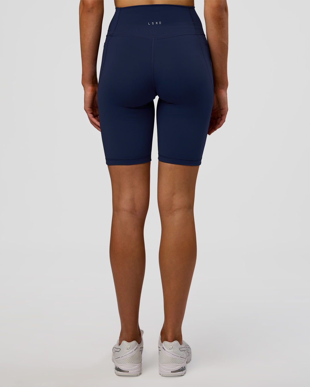 Woman wearing Fusion Ultra High-Rise 9" Short Pockets - Future Navy | Model:Evie | Size:S - view 3