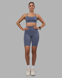 Woman wearing Fusion Ultra High-Rise 9" Short Pockets - Night Shadow | Model:Rhiley | Size:S | Thumbnail Index: 1