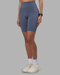 Woman wearing Fusion Ultra High-Rise 9" Short Pockets - Night Shadow | Model:Rhiley | Size:S | Thumbnail Index: 0
