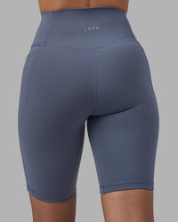 Woman wearing Fusion Ultra High-Rise 9" Short Pockets - Night Shadow | Model:Rhiley | Size:S | Thumbnail Index: 7