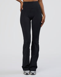 Woman wearing Fusion Ultra High-Rise Flared Tall Legging Pockets - Black | Model:Tomi | Size:S | Thumbnail Index: 0