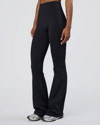 Woman wearing Fusion Ultra High-Rise Flared Tall Legging Pockets - Black | Model:Tomi | Size:S | Thumbnail Index: 4