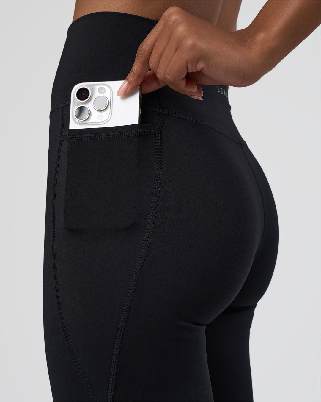 Woman wearing Fusion Ultra High-Rise Flared Tall Legging Pockets - Black | Model:Tomi | Size:S - view 2