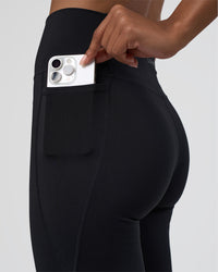 Woman wearing Fusion Ultra High-Rise Flared Tall Legging Pockets - Black | Model:Tomi | Size:S | Thumbnail Index: 1