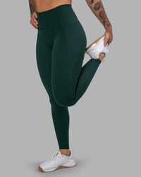 Woman wearing Fusion Ultra High-Rise Full Length Legging Pockets - Dark Moss | Model:Robyn | Size:S | Thumbnail Index: 0