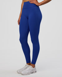 Woman wearing Fusion Ultra High-Rise Full Length Legging Pockets - Electric Indigo | Model:Evie | Size:S | Thumbnail Index: 1