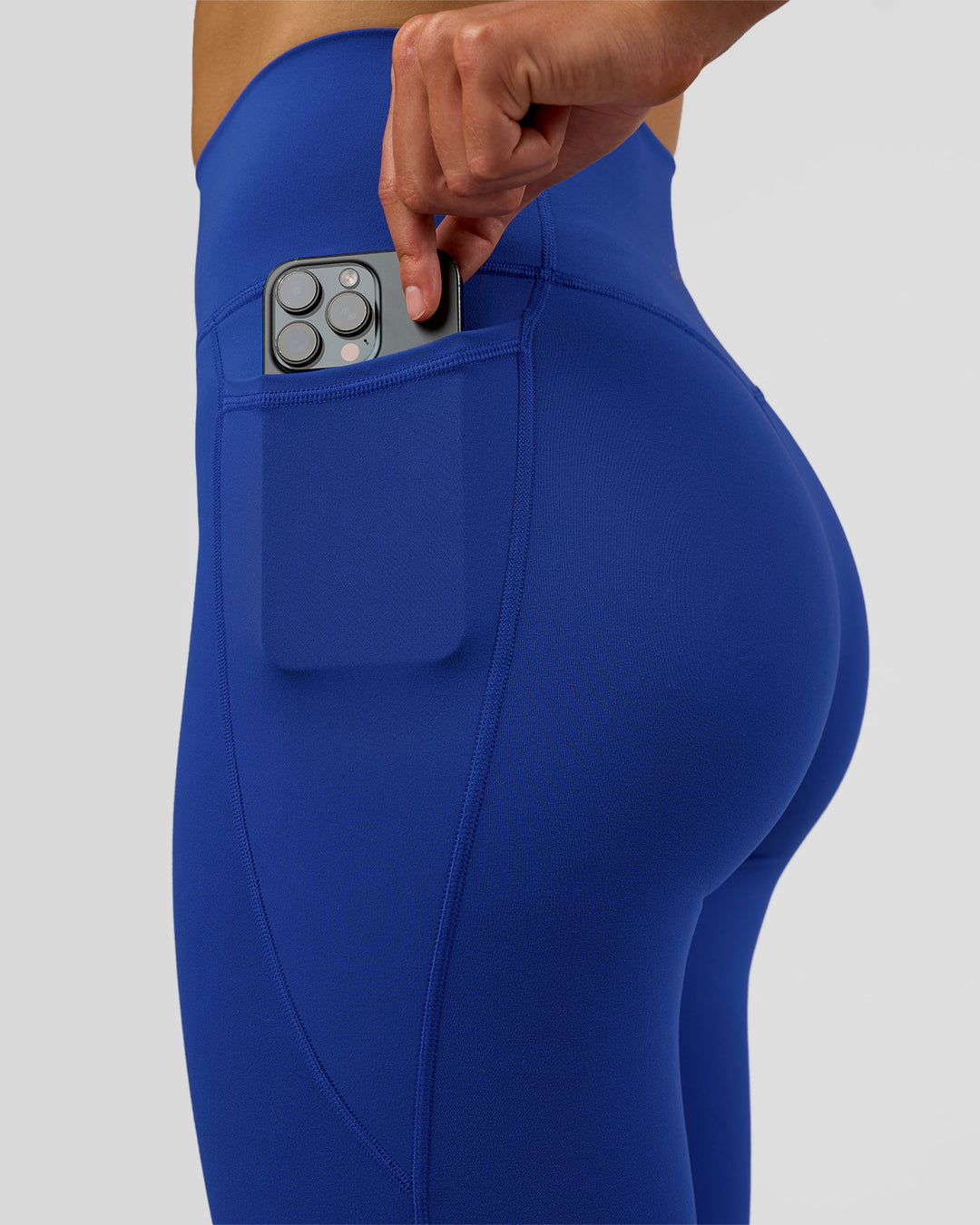 Woman wearing Fusion Ultra High-Rise Full Length Legging Pockets - Electric Indigo | Model:Evie | Size:S - view 3