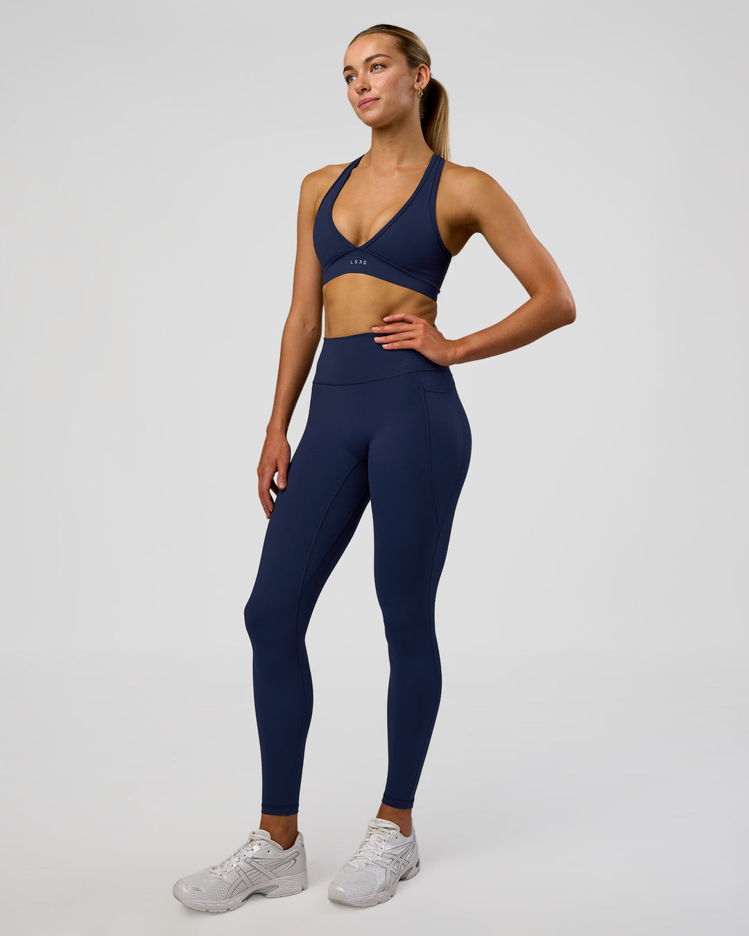 Woman wearing Fusion Ultra High-Rise Full Length Legging Pockets - Future Navy | Model:Evie | Size:S - view 1