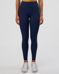 Woman wearing Fusion Ultra High-Rise Full Length Legging Pockets - Future Navy | Model:Evie | Size:S | Thumbnail Index: 1