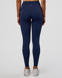 Woman wearing Fusion Ultra High-Rise Full Length Legging Pockets - Future Navy | Model:Evie | Size:S | Thumbnail Index: 3